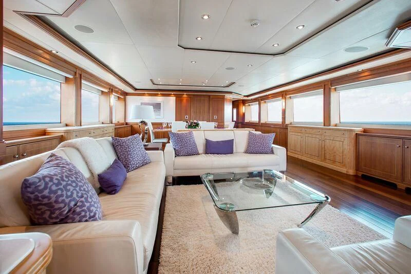 a living room with a couch and a coffee table aboard BLACK SHEEP Yacht for Sale