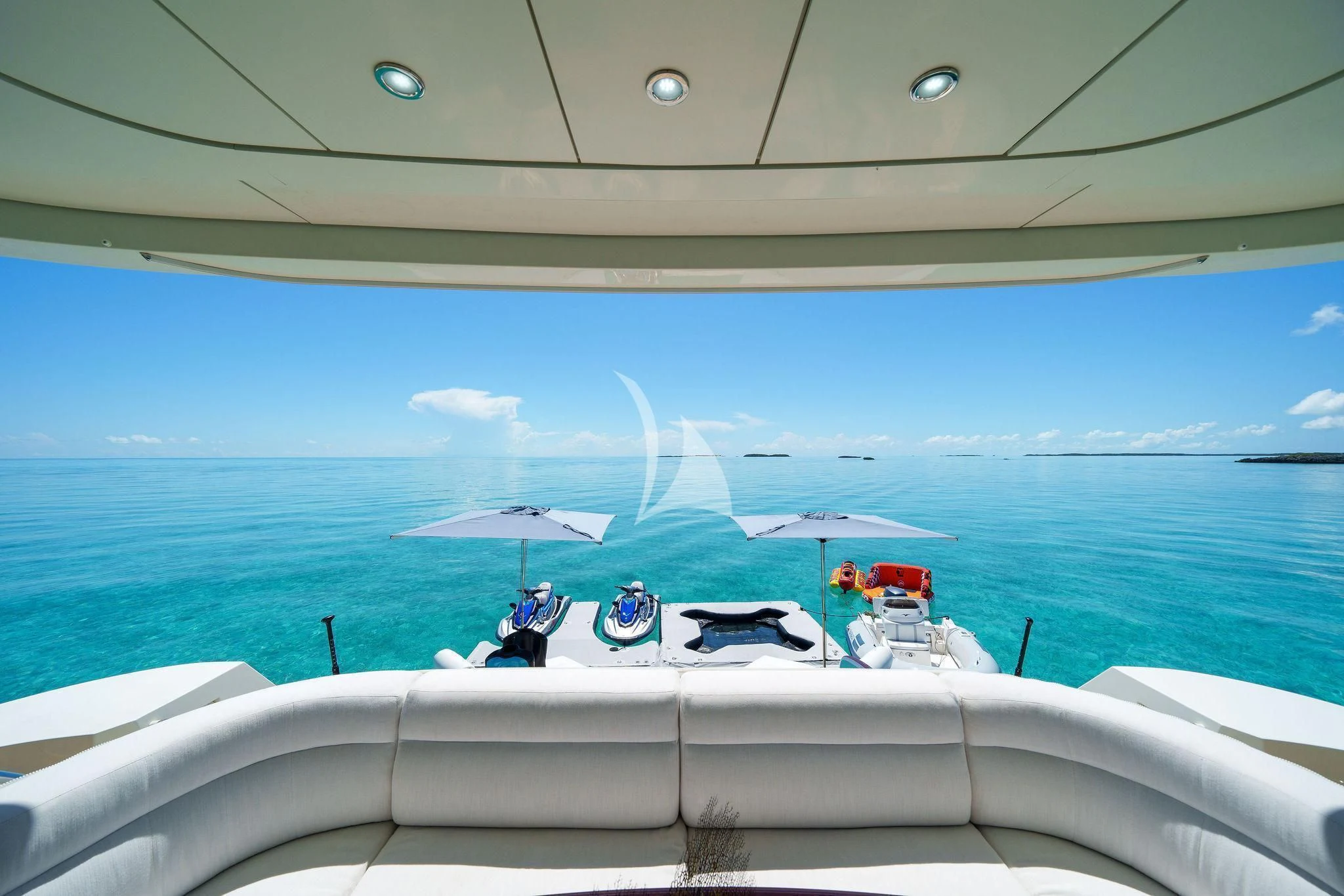 a group of people sitting on a lounge chair on a beach aboard BLACK SHEEP Yacht for Sale