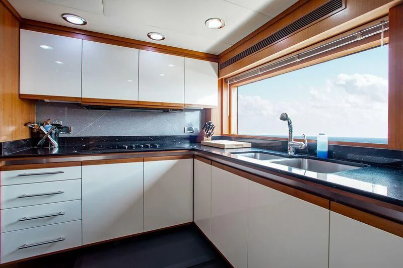 a kitchen with a large window aboard BLACK SHEEP Yacht for Sale