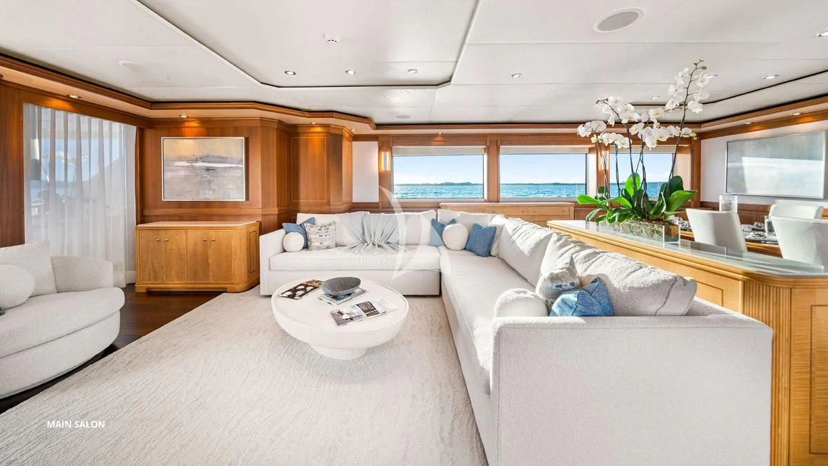a living room with a couch and a table aboard BLACK SHEEP Yacht for Sale