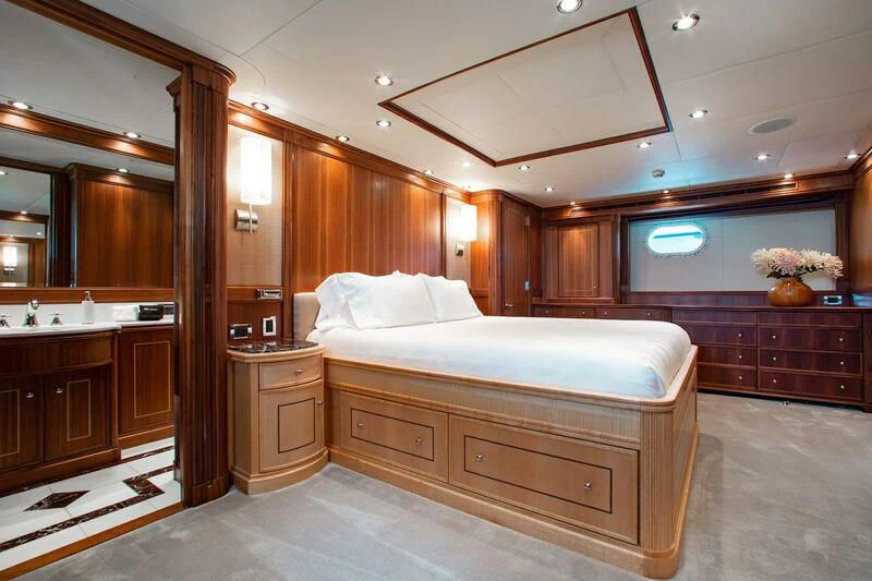 a bedroom with a bed and cabinets aboard BLACK SHEEP Yacht for Sale