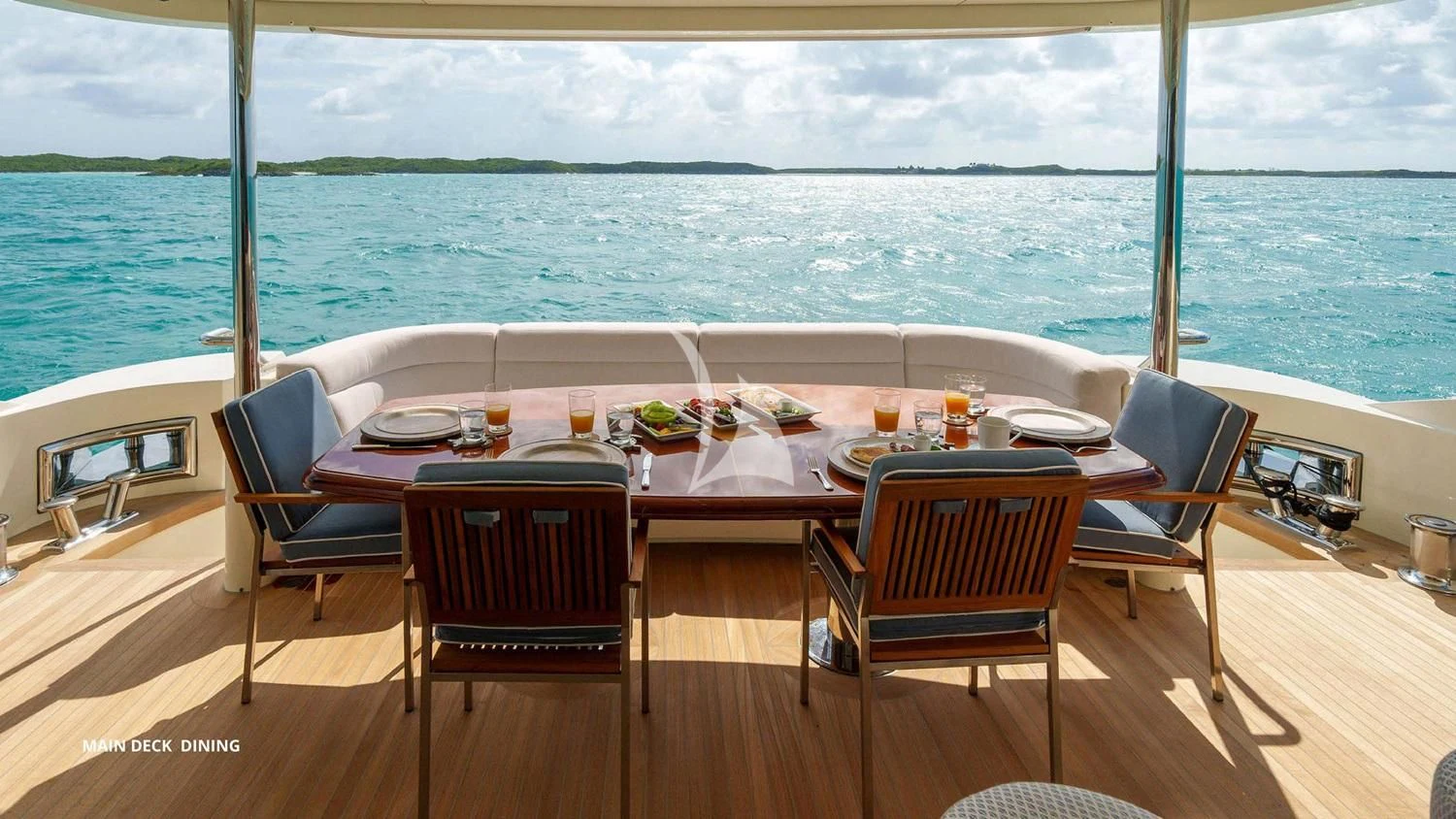 a table with chairs and food on it aboard BLACK SHEEP Yacht for Sale