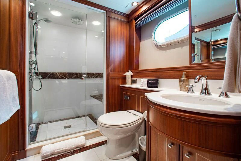 a bathroom with a glass shower door aboard BLACK SHEEP Yacht for Sale