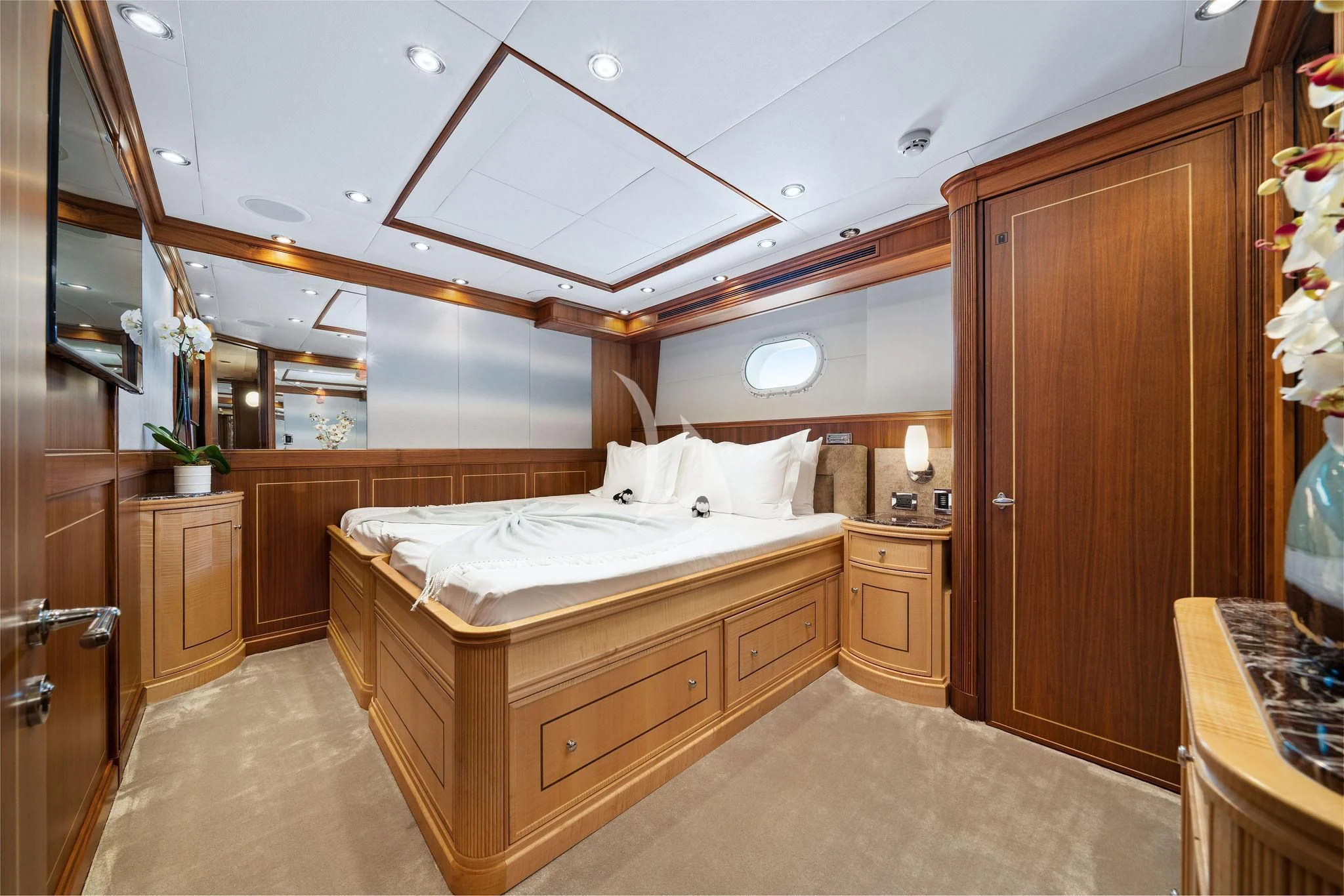 a bedroom with a bed and a wood cabinet aboard BLACK SHEEP Yacht for Sale