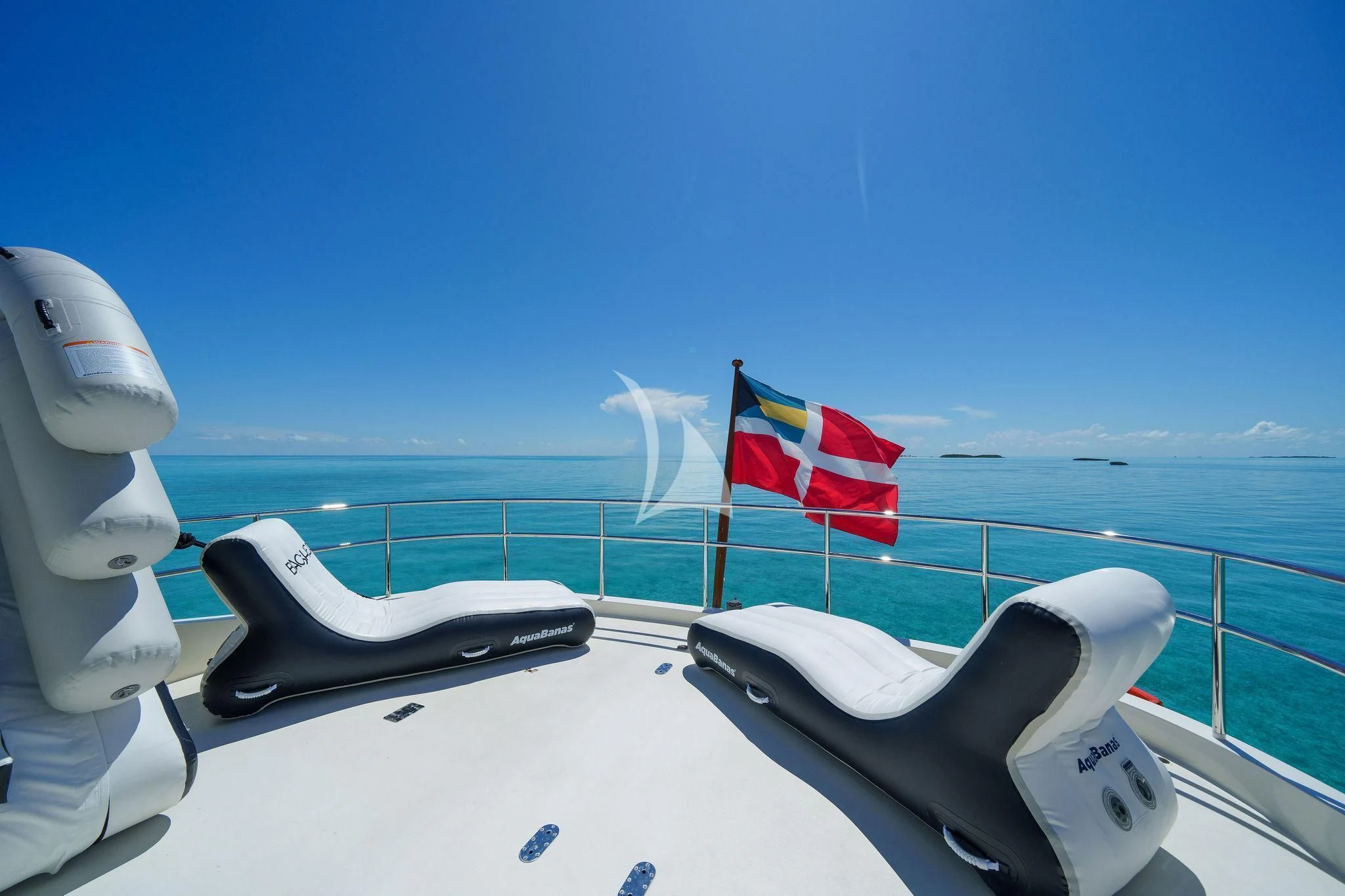 a boat with a flag on the front aboard BLACK SHEEP Yacht for Sale
