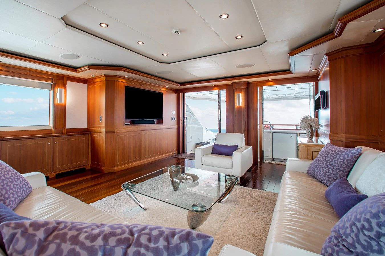 a living room with a couch and a coffee table aboard BLACK SHEEP Yacht for Sale