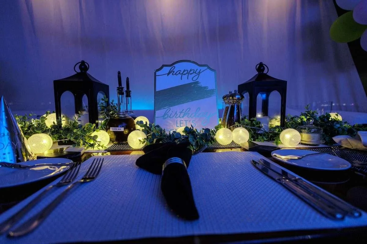 a table with plates and flowers aboard BLACK SHEEP Yacht for Sale