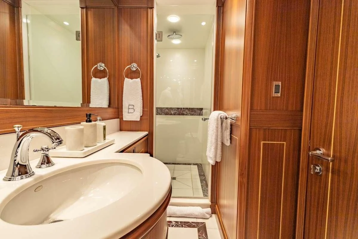 a bathroom with a sink and a mirror aboard BLACK SHEEP Yacht for Sale