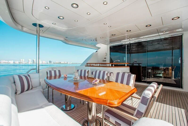 a table and chairs on a boat aboard BLACK SHEEP Yacht for Sale