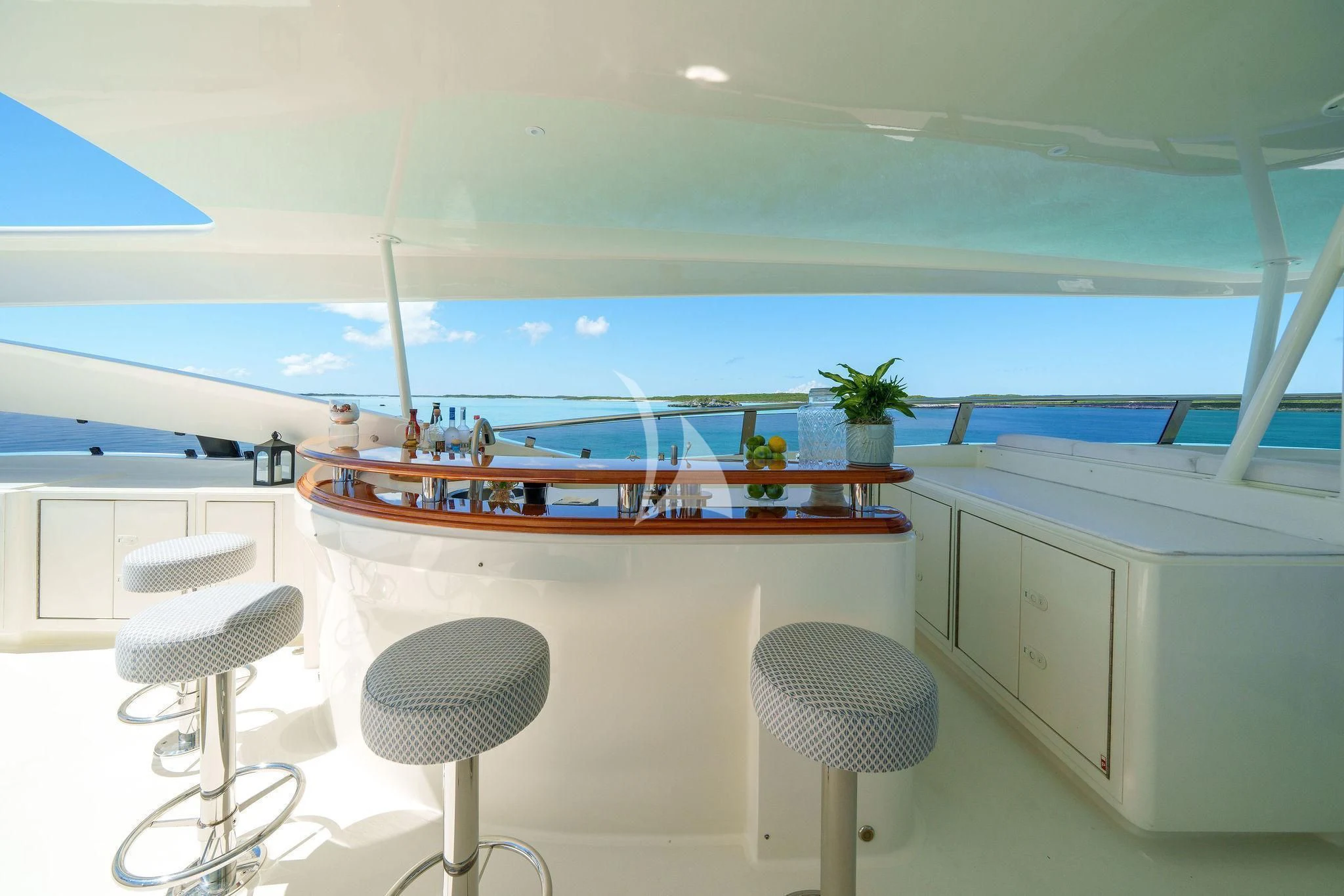 a room with a bar stools and a table and chairs aboard BLACK SHEEP Yacht for Sale