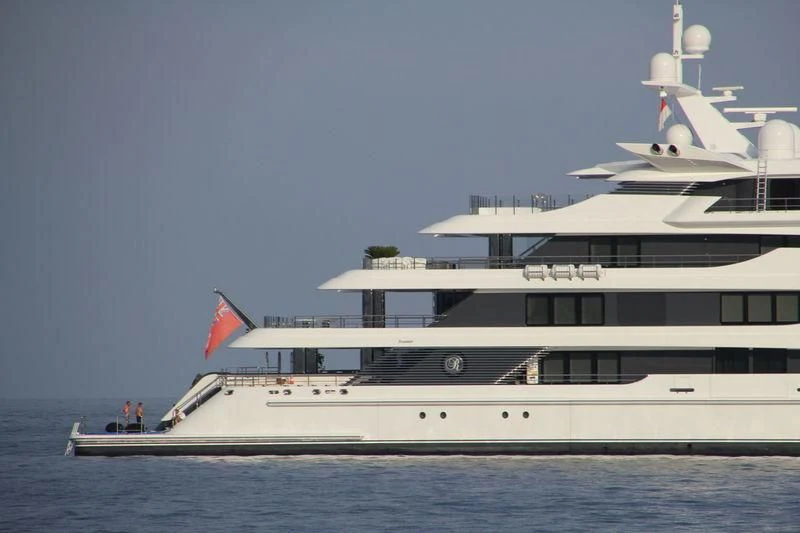 a large white boat with a flag on the front aboard ROYAL ROMANCE Yacht for Sale