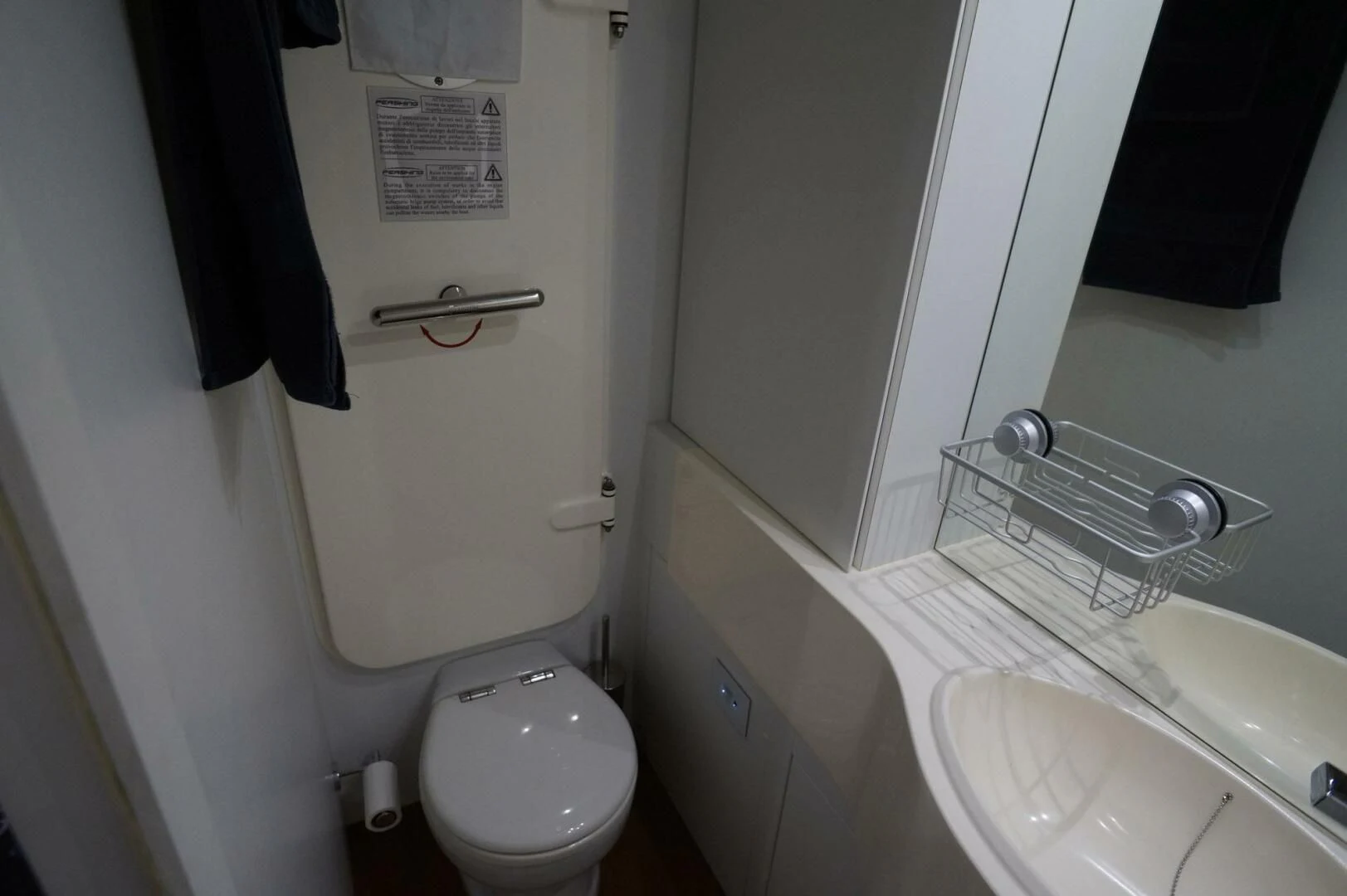 a bathroom with a toilet and sink aboard THE OFFICE Yacht for Sale