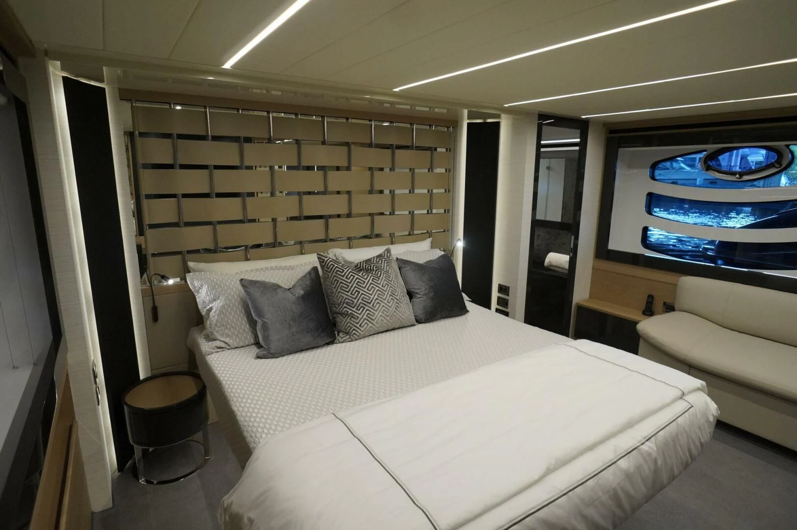 a bed with a white bed spread aboard THE OFFICE Yacht for Sale