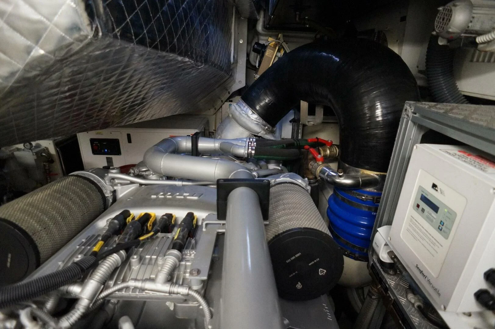 a car engine with a black pipe aboard THE OFFICE Yacht for Sale
