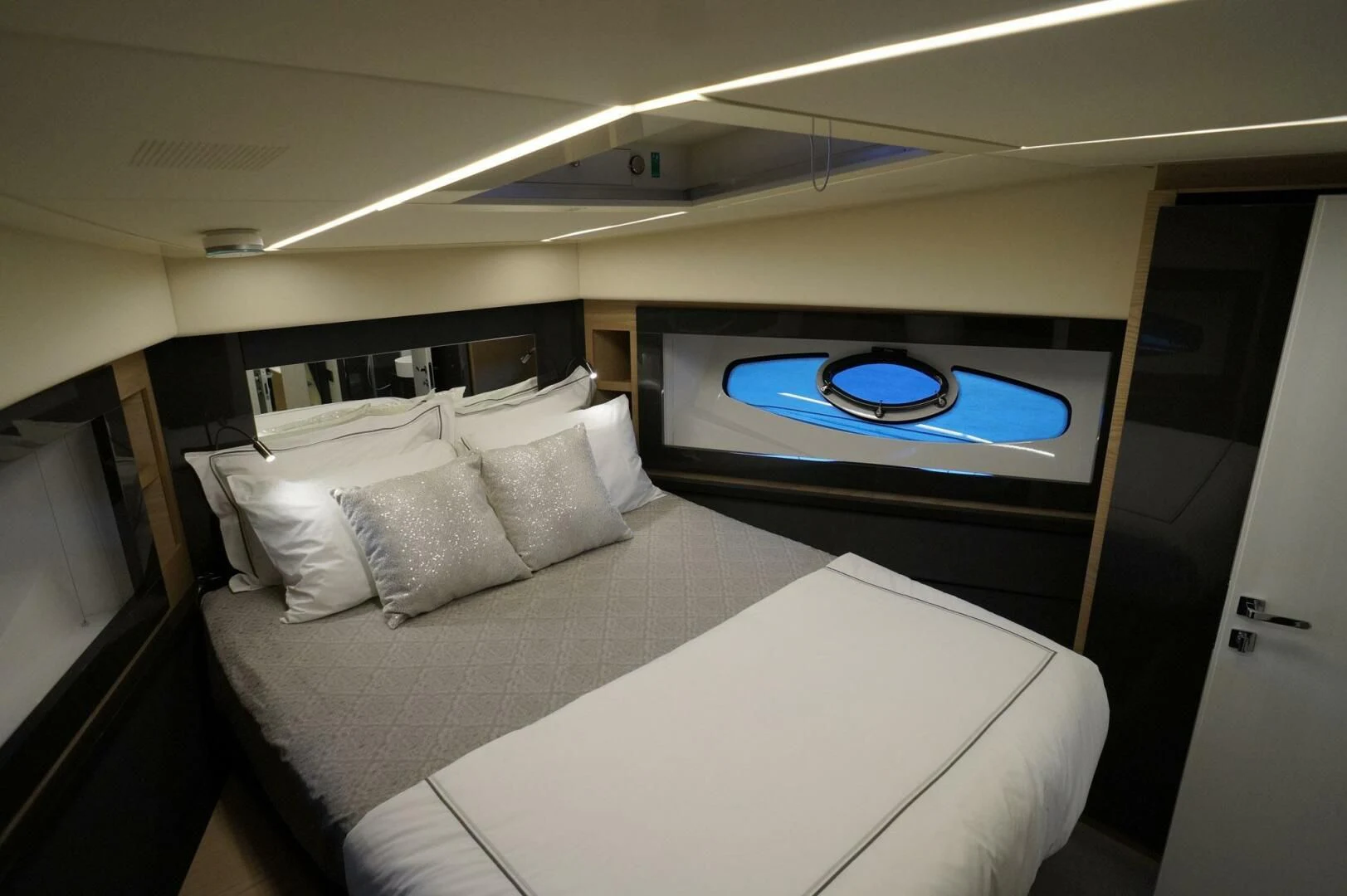 a bed with a large screen aboard THE OFFICE Yacht for Sale