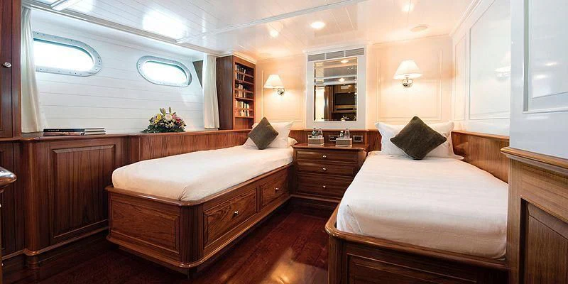 a room with a bed and a desk aboard V6 Yacht for Sale