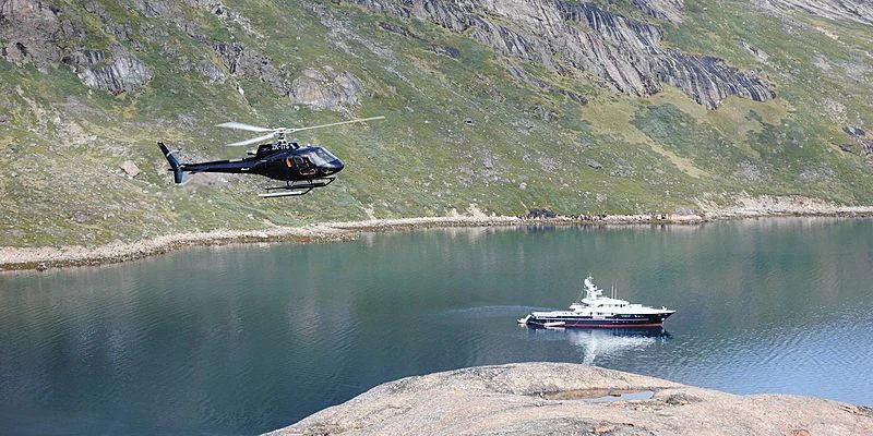 a helicopter flying over a body of water aboard V6 Yacht for Sale