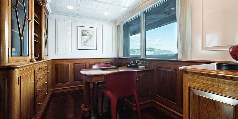 a kitchen with a table and chairs aboard V6 Yacht for Sale