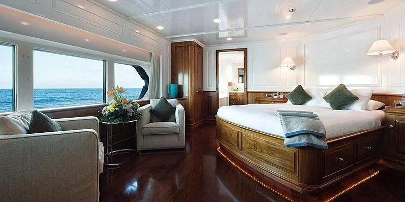 a large bedroom with a large bed aboard V6 Yacht for Sale