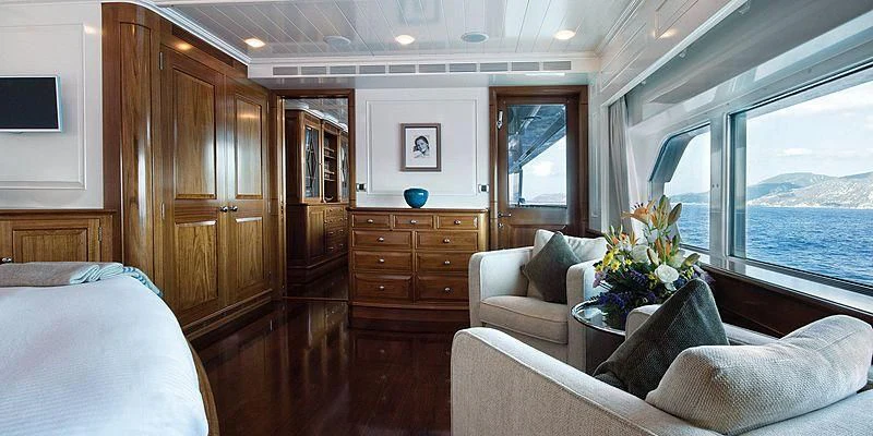 a room with a bed and a couch aboard V6 Yacht for Sale