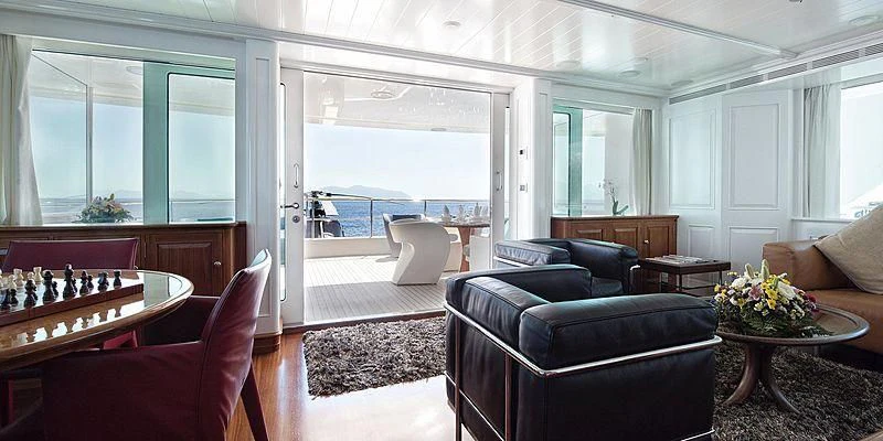 a living room with a large window aboard V6 Yacht for Sale