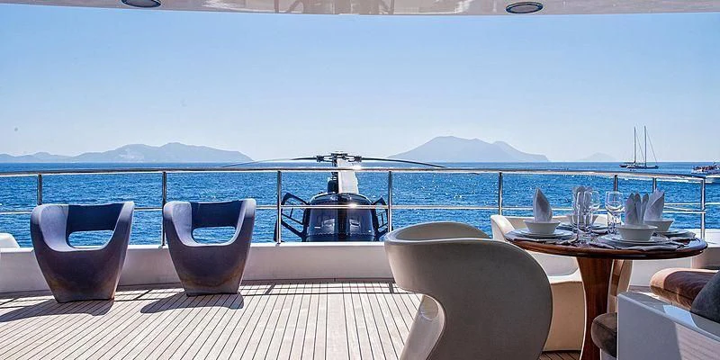 a table set for a meal on a deck overlooking the ocean aboard V6 Yacht for Sale