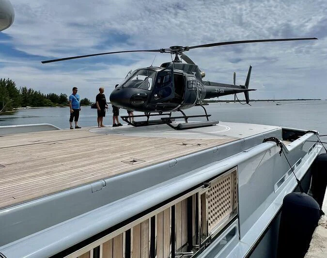 a helicopter on a deck aboard V6 Yacht for Sale