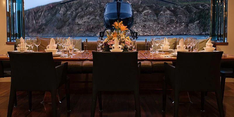 a table set with wine glasses aboard V6 Yacht for Sale