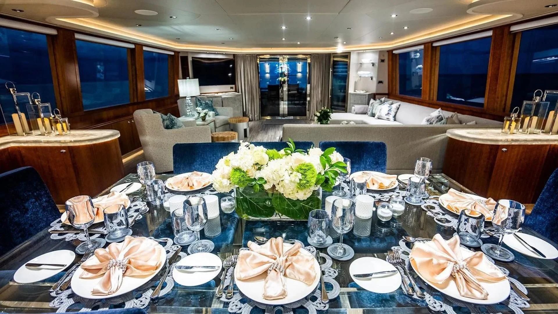 a large table with plates and glasses aboard KEMOSABE Yacht for Charter