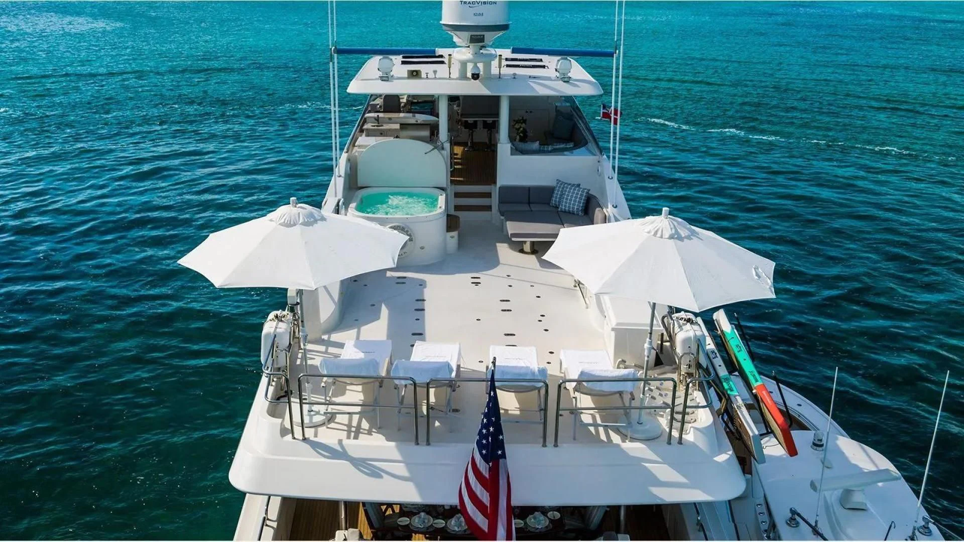 a boat with a flag on it aboard KEMOSABE Yacht for Charter