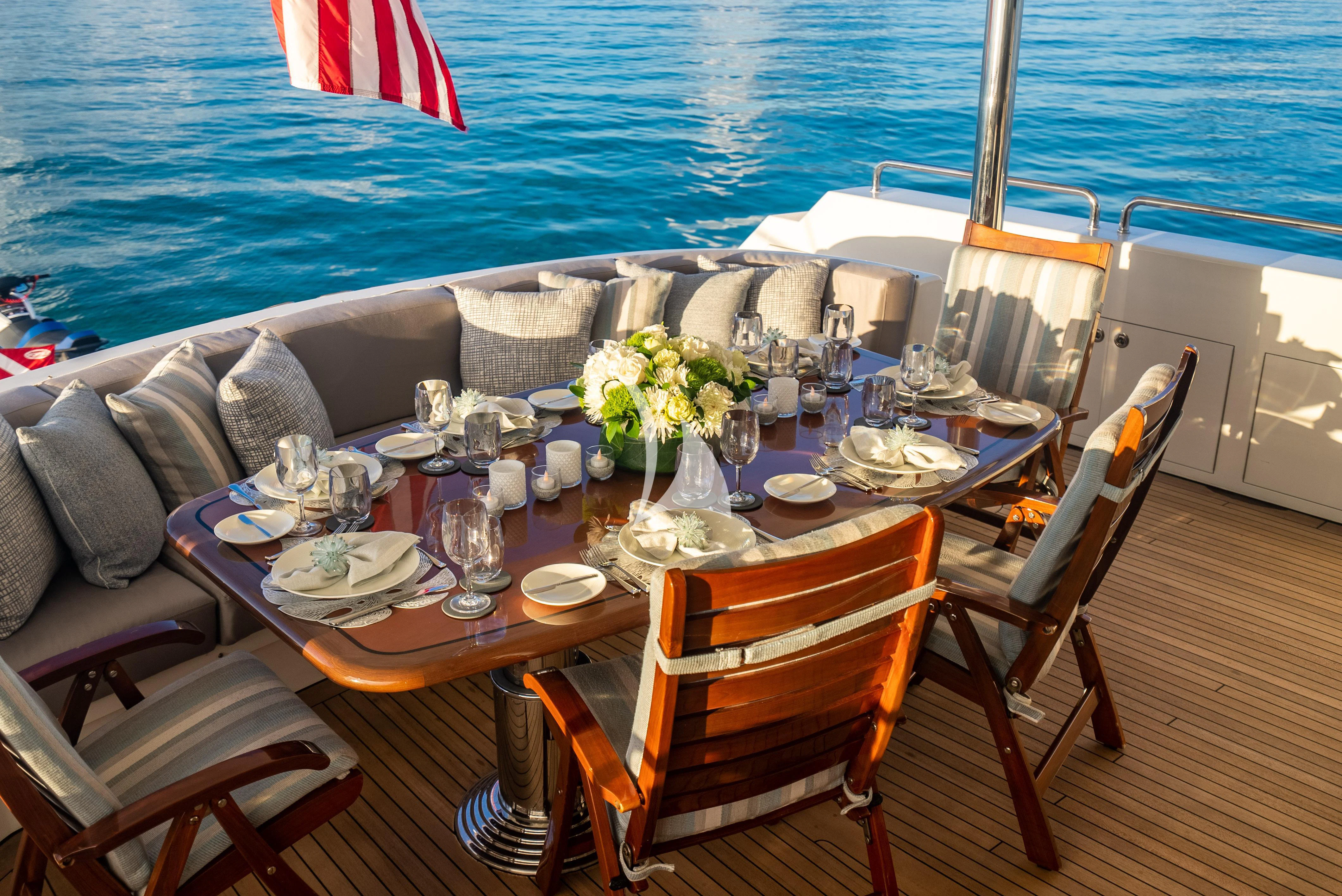 a table set for a dinner on a boat aboard KEMOSABE Yacht for Charter