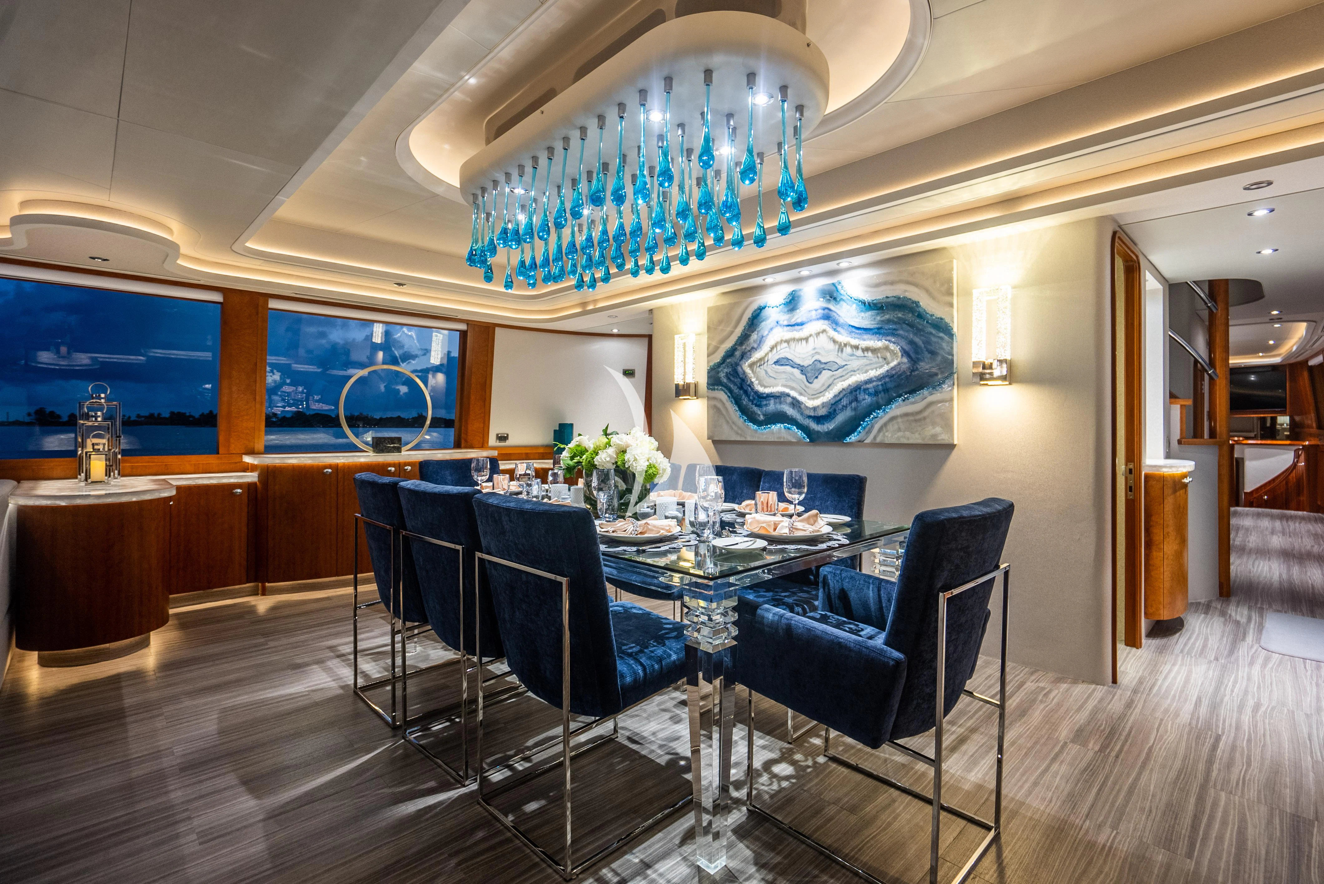 a large room with a table and chairs aboard KEMOSABE Yacht for Charter