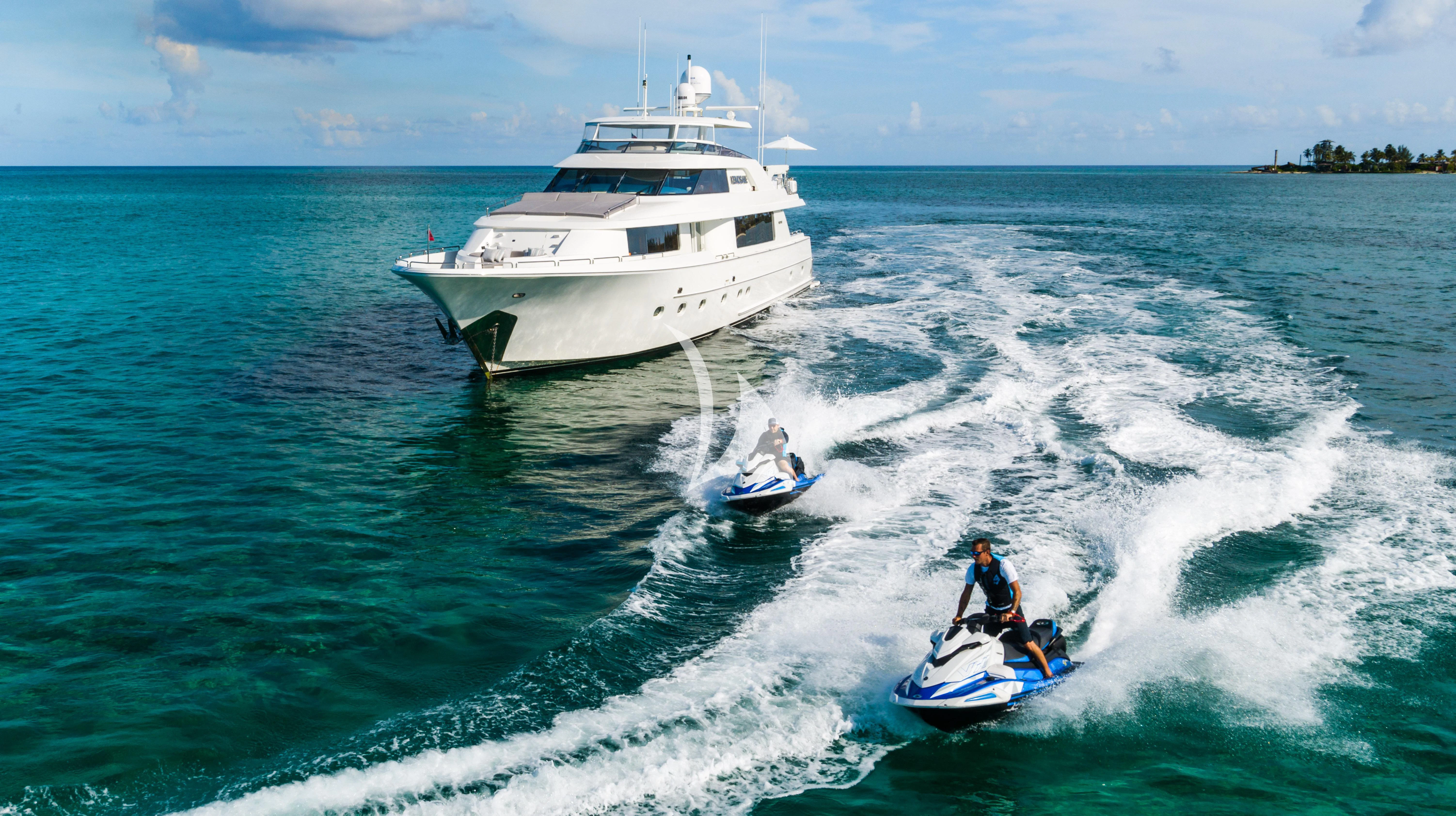 a man on a jet ski behind a boat on the water aboard KEMOSABE Yacht for Charter
