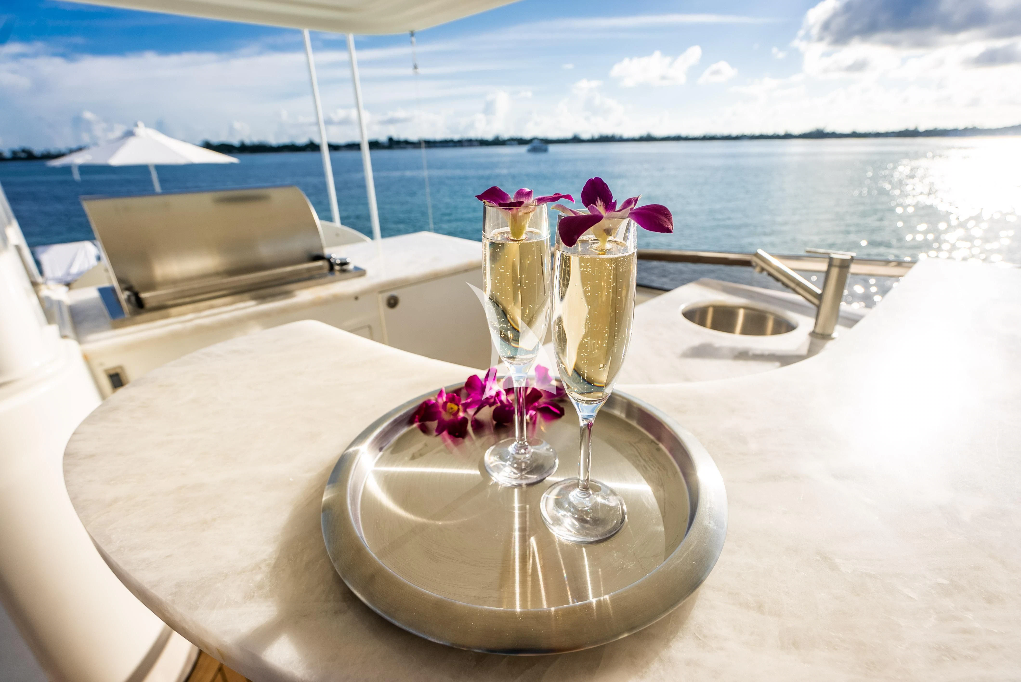 a table with glasses and drinks on it aboard KEMOSABE Yacht for Charter
