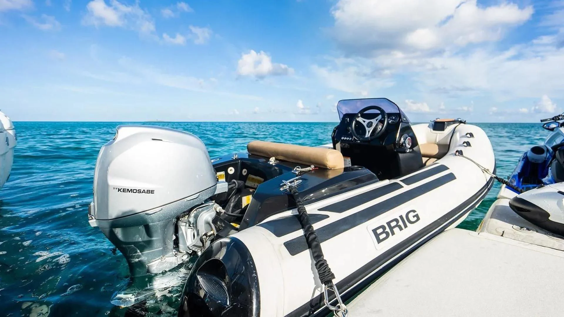 a boat with a motor and helmet on the front aboard KEMOSABE Yacht for Charter