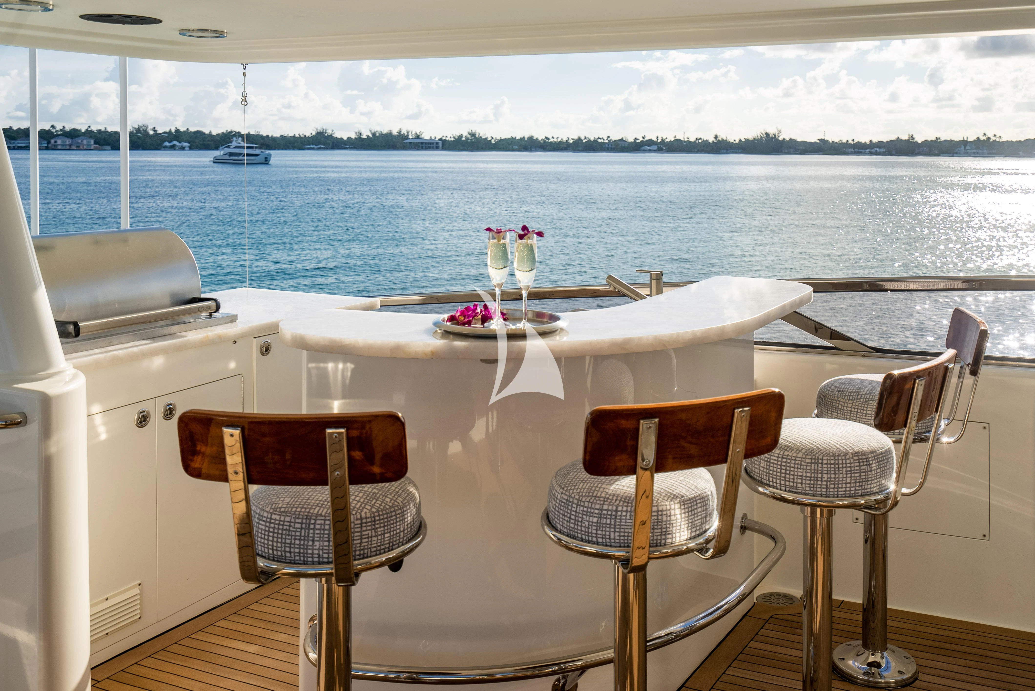 a table with wine glasses on it aboard KEMOSABE Yacht for Charter