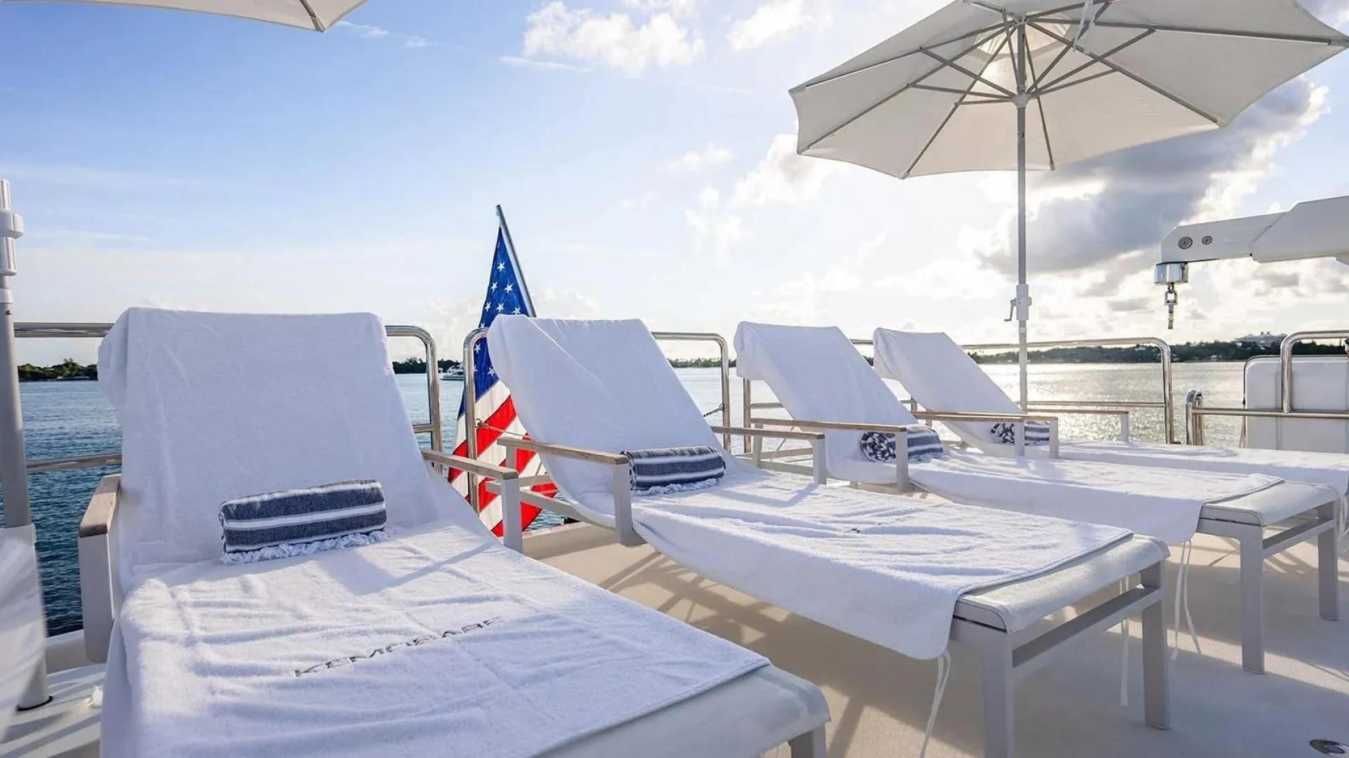a group of chairs and umbrellas on a beach aboard KEMOSABE Yacht for Charter
