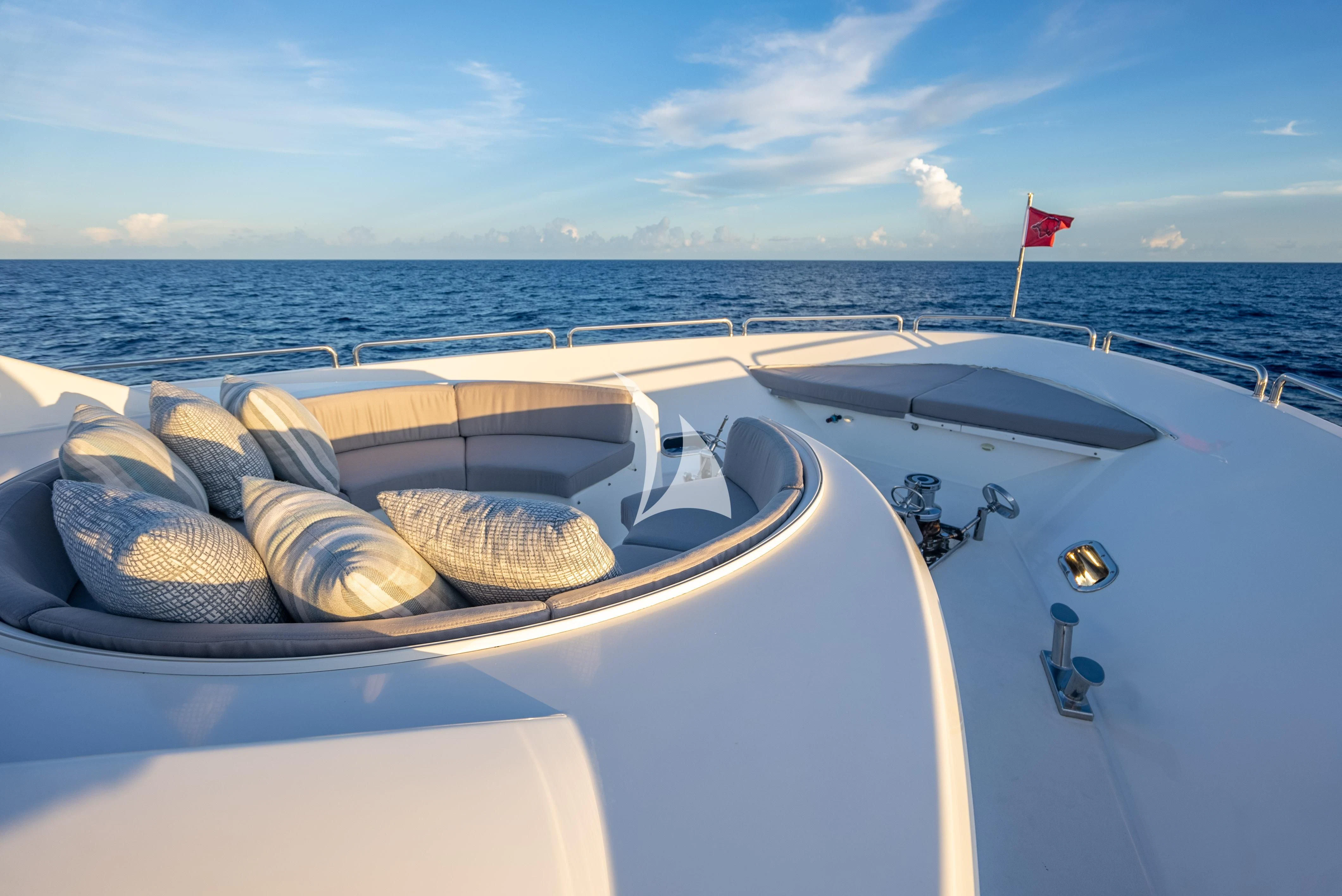 a boat with a flag on the front aboard KEMOSABE Yacht for Charter