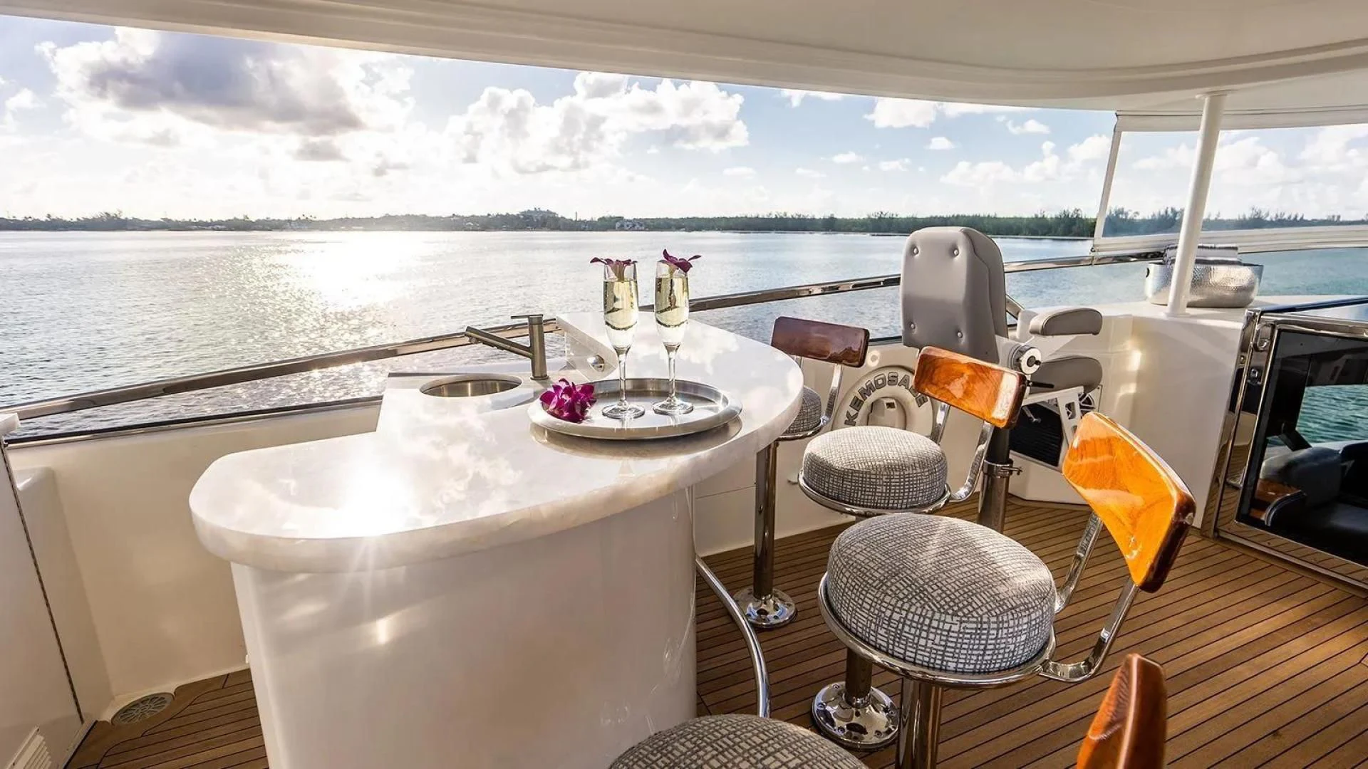 a table with glasses and a plate on it aboard KEMOSABE Yacht for Charter