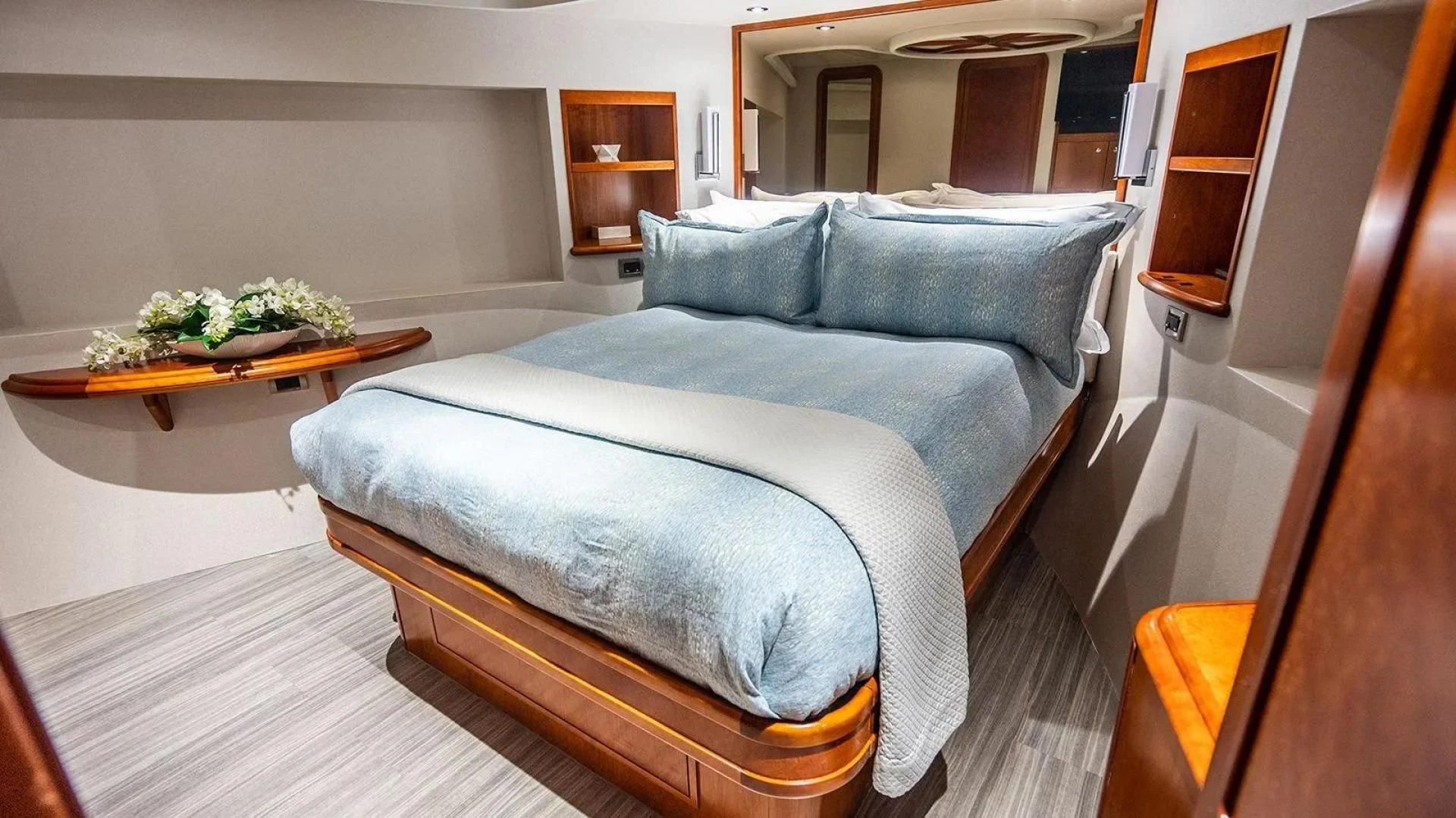 a bedroom with a bed and a table aboard KEMOSABE Yacht for Charter