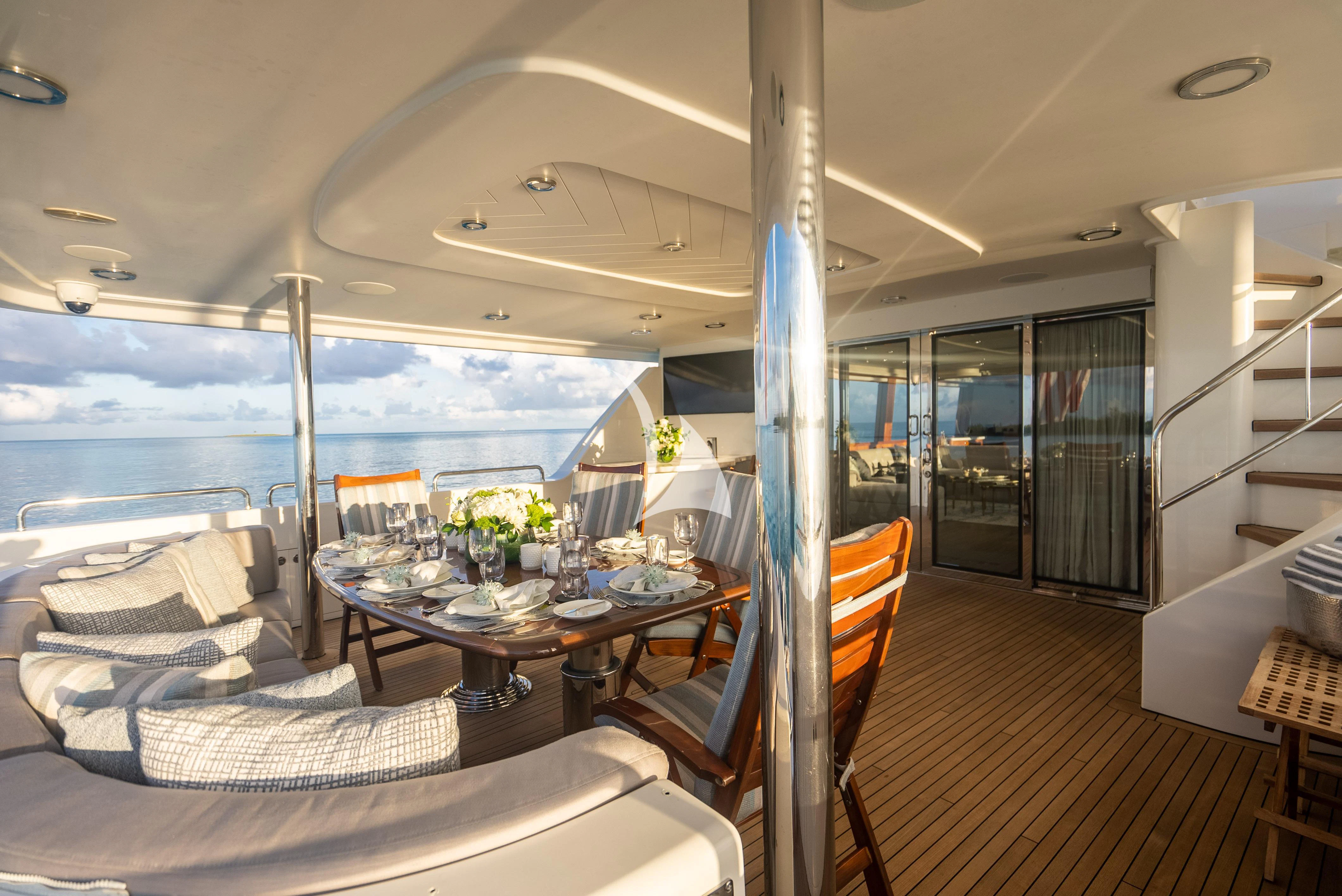 a boat with a table and chairs aboard KEMOSABE Yacht for Charter