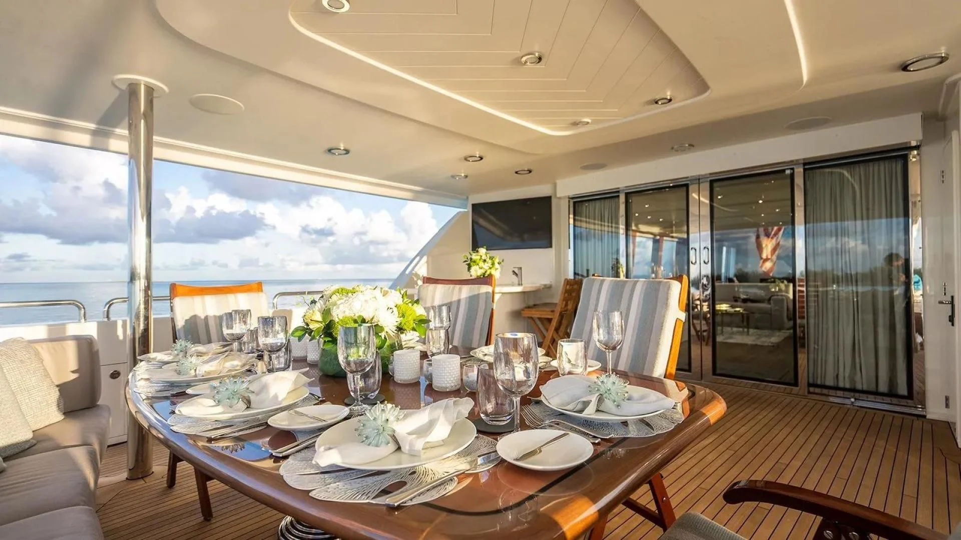 a dining table with plates and glasses aboard KEMOSABE Yacht for Charter