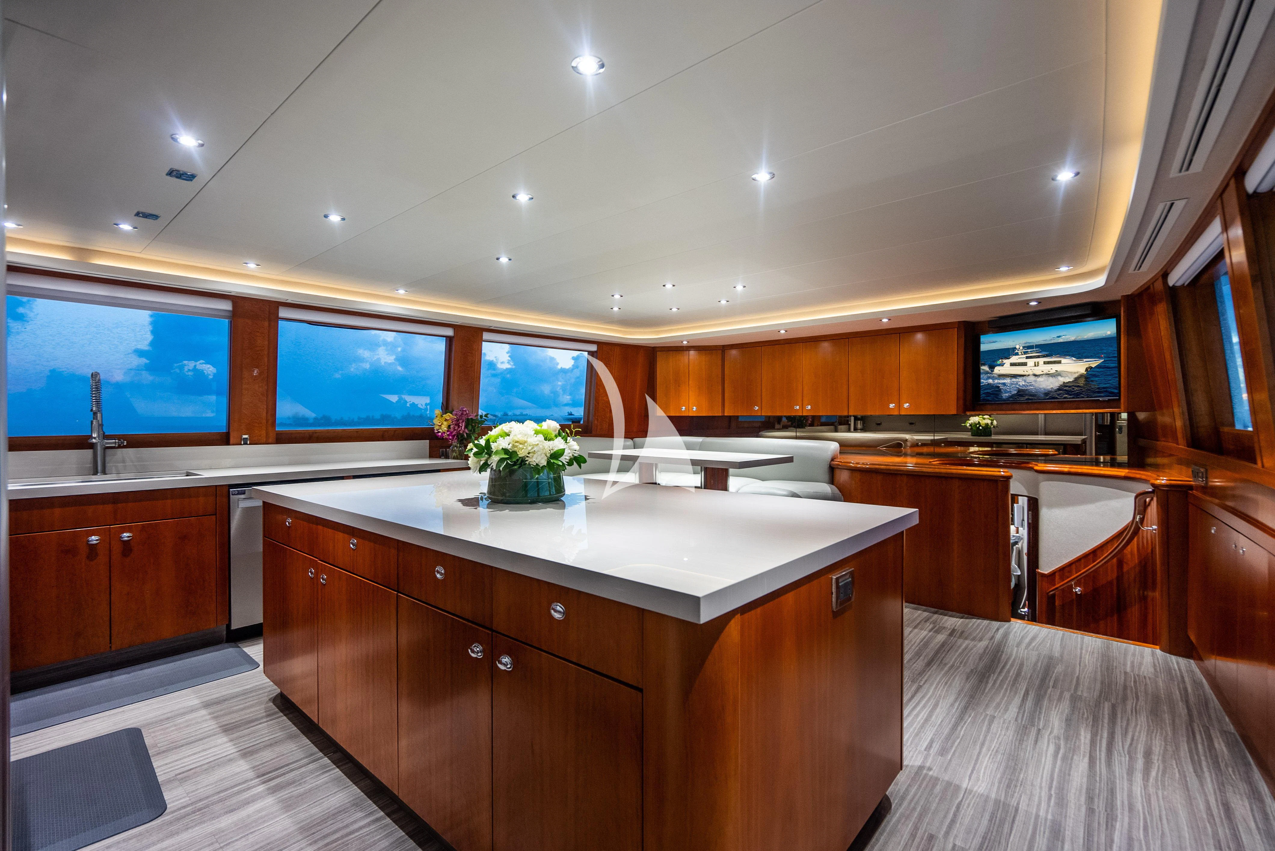 a kitchen with wooden cabinets aboard KEMOSABE Yacht for Charter