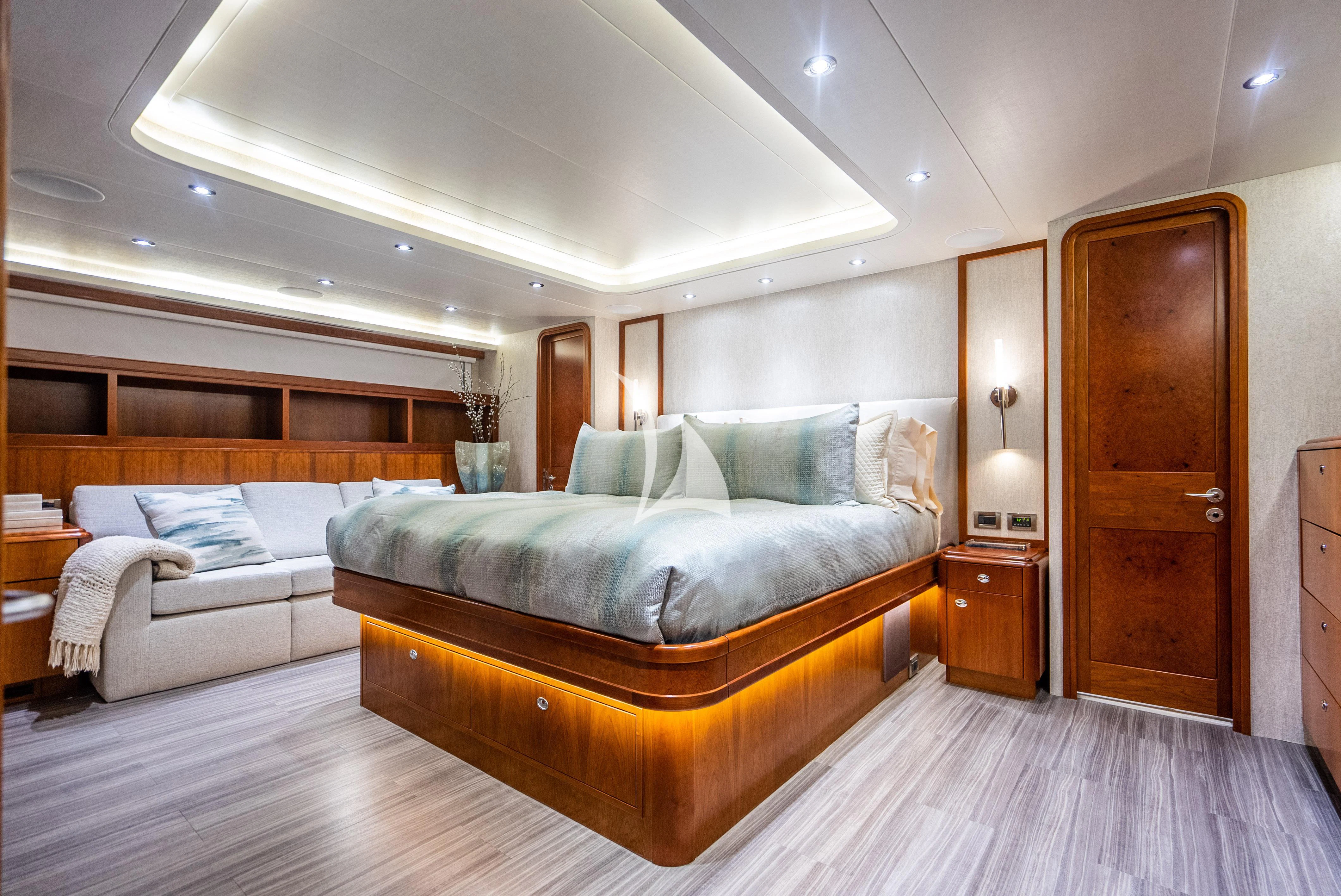 a large bedroom with a bed and a couch aboard KEMOSABE Yacht for Charter