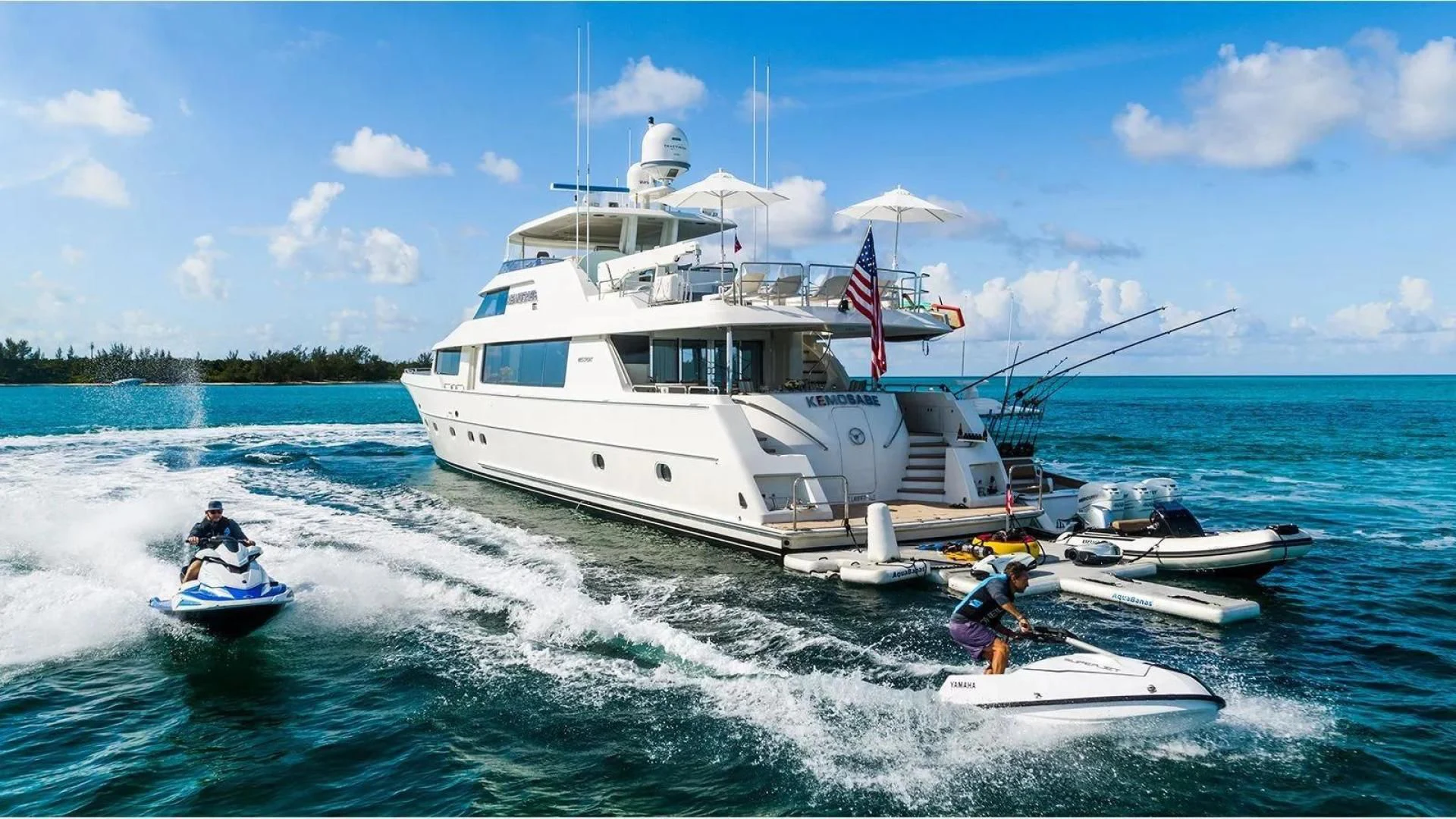 a boat with a flag on it aboard KEMOSABE Yacht for Charter