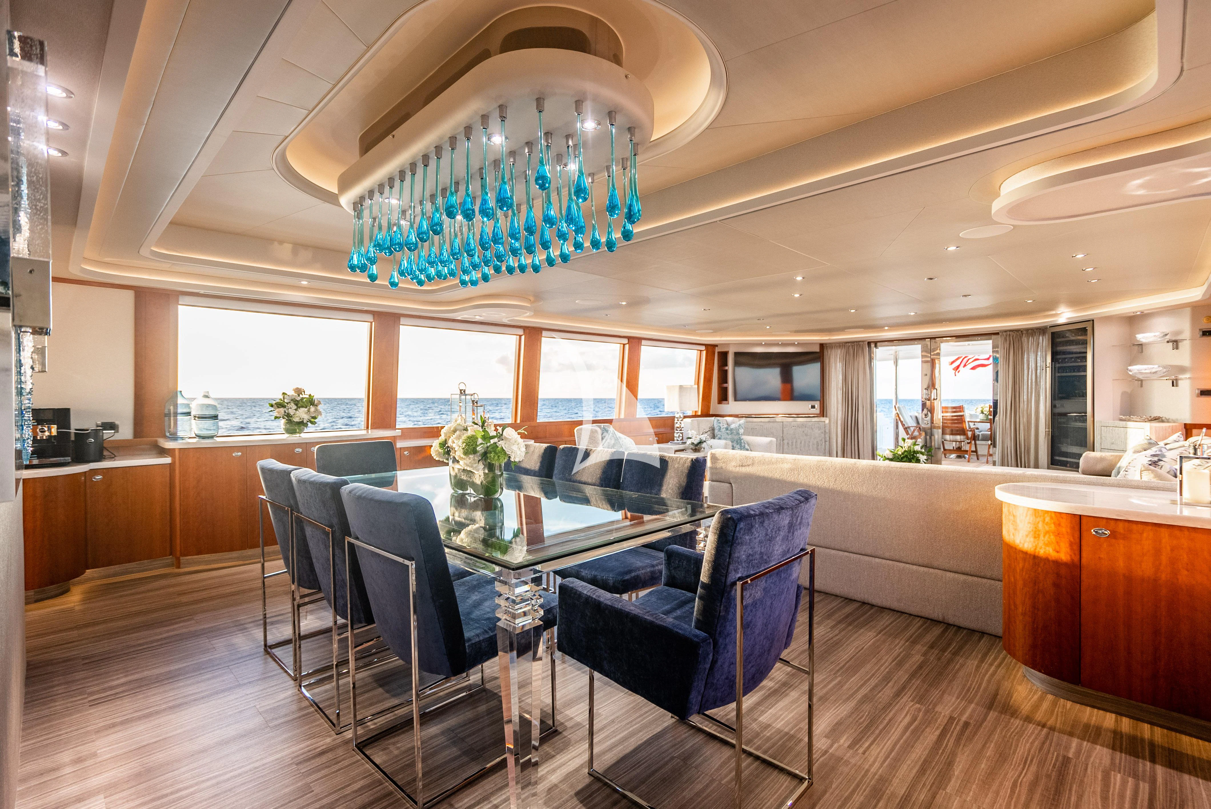 a large room with a table and chairs aboard KEMOSABE Yacht for Charter