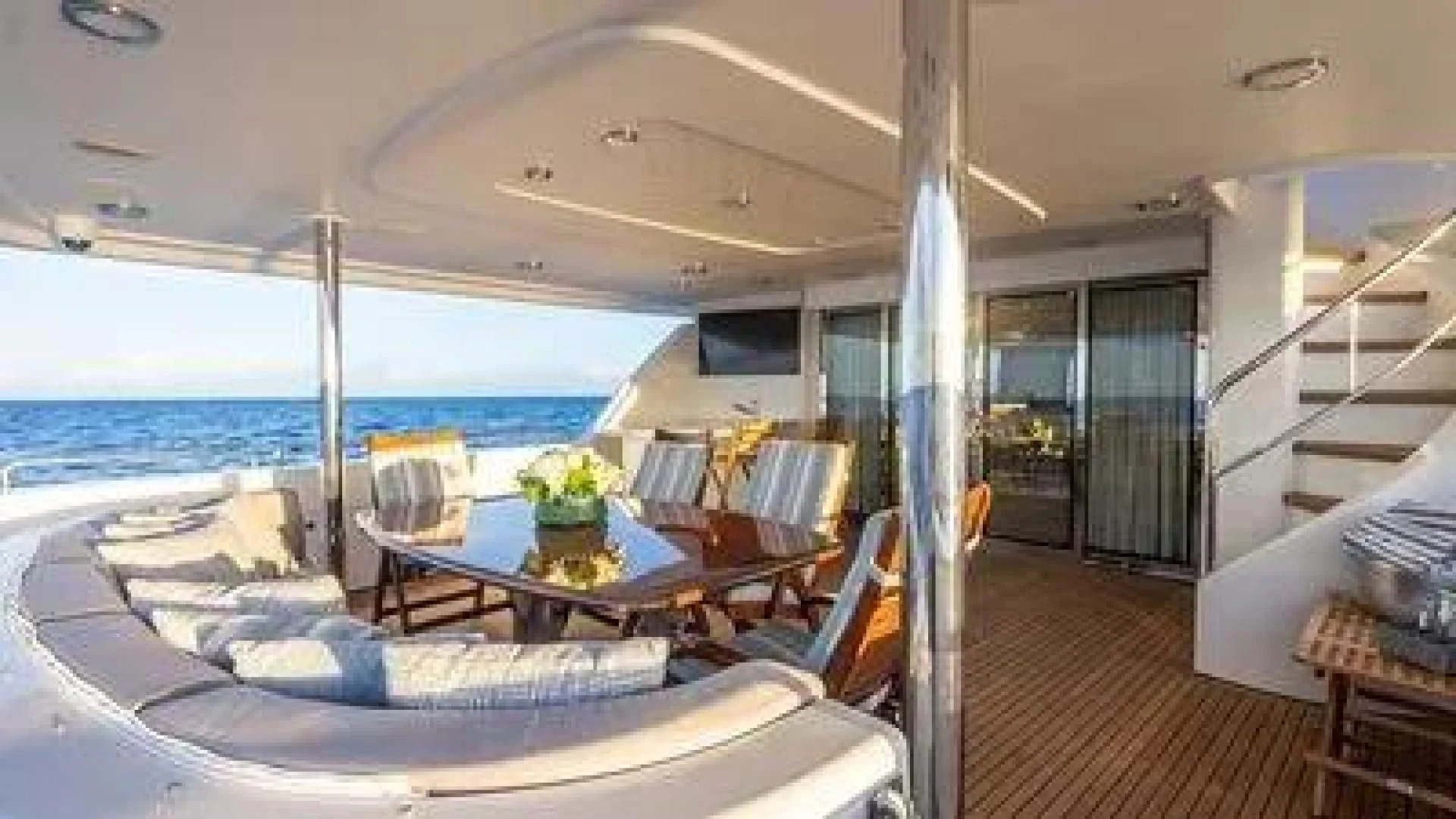 a large living room with a large balcony overlooking the ocean aboard KEMOSABE Yacht for Charter