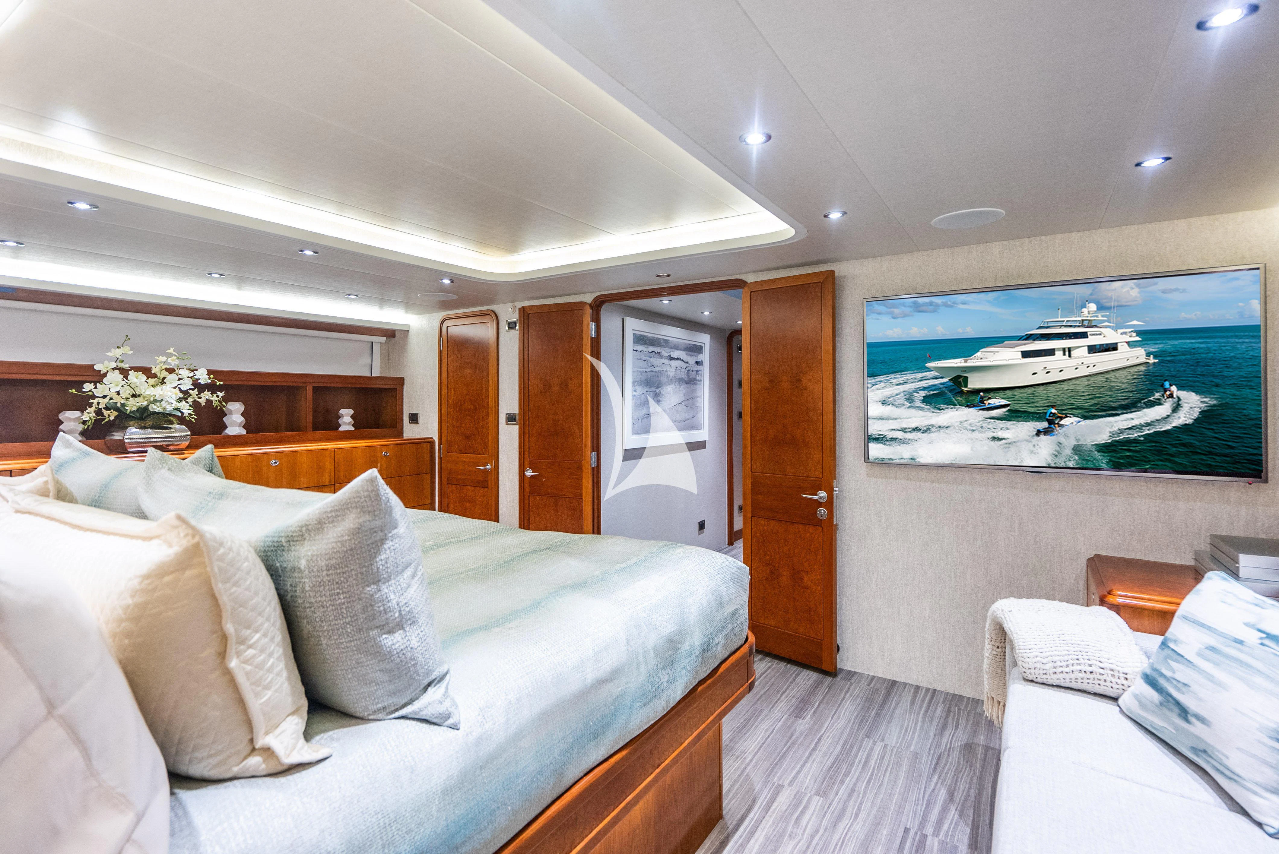 a room with a bed and a fish tank aboard KEMOSABE Yacht for Charter