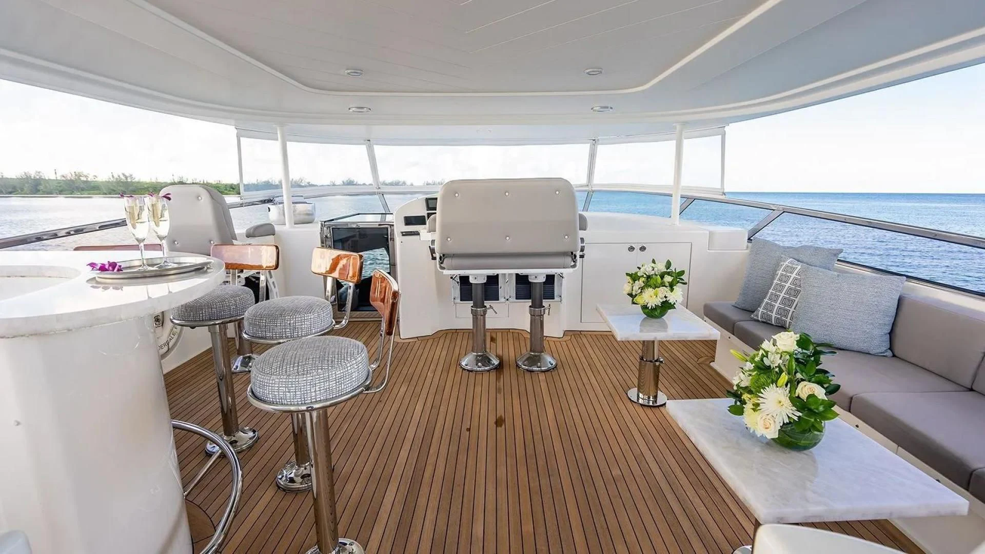a room with a table chairs and a couch aboard KEMOSABE Yacht for Charter