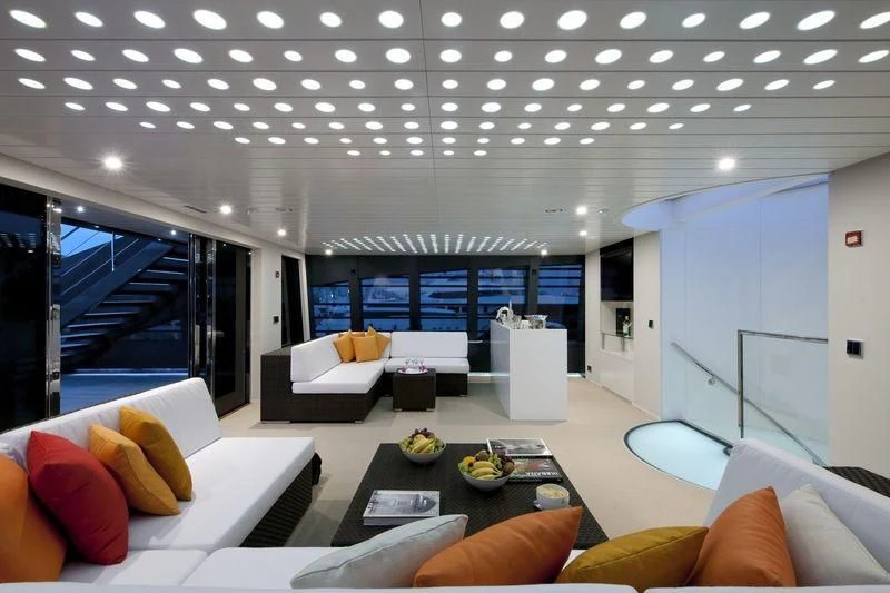 a modern living room with a large window aboard OCEAN SAPPHIRE Yacht for Sale